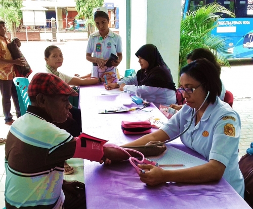 Perawat Yuniyati Abineno, Amd. Kep. dan Sri Herlin Ernawati, S. Kep. Ns. sedang melakukan pemeriksaan kesehatan sederhana di Posyandu Lansia Pniel I